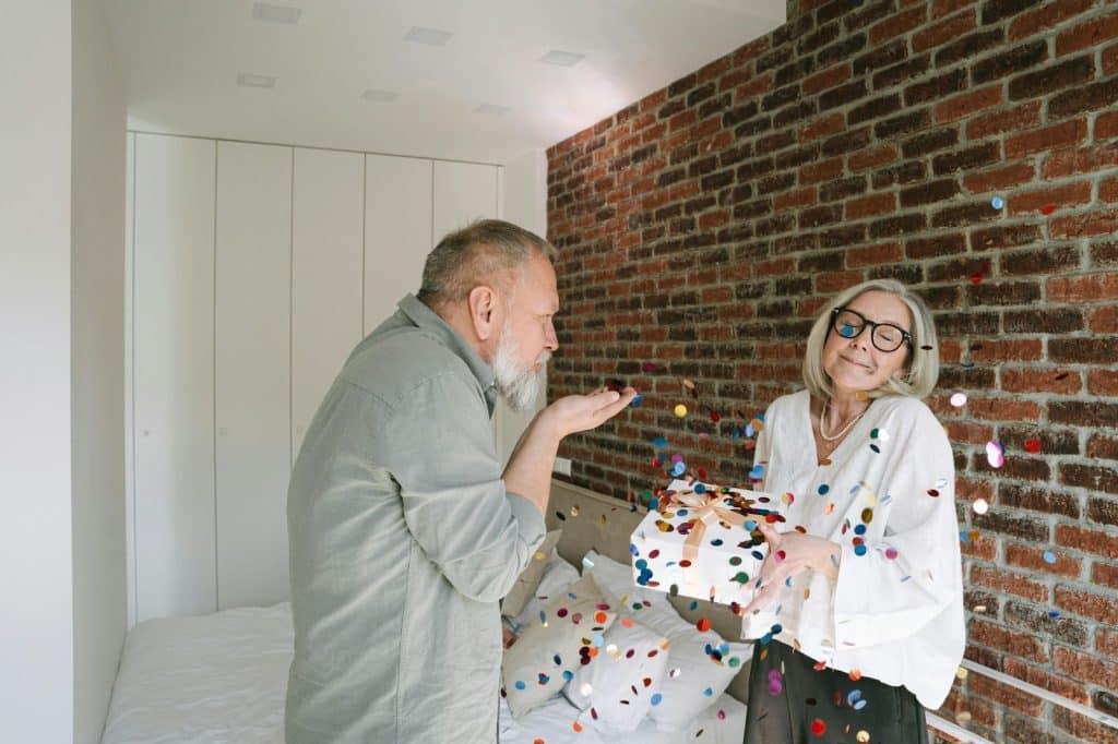 A man and woman celebrating anniversary with confetti
