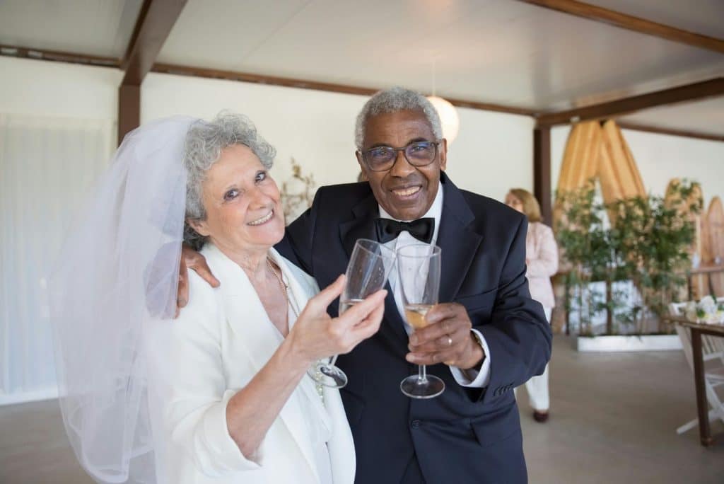 A married couple with wine glass on their hands