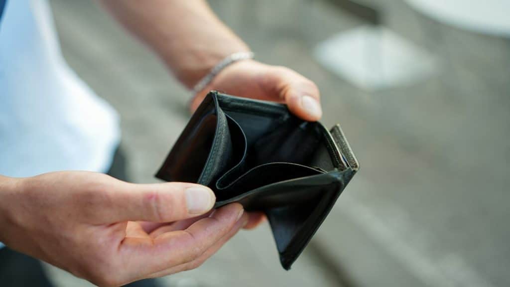 A man holding an empty wallet