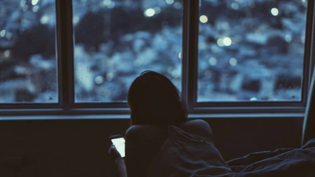 A woman texting at night