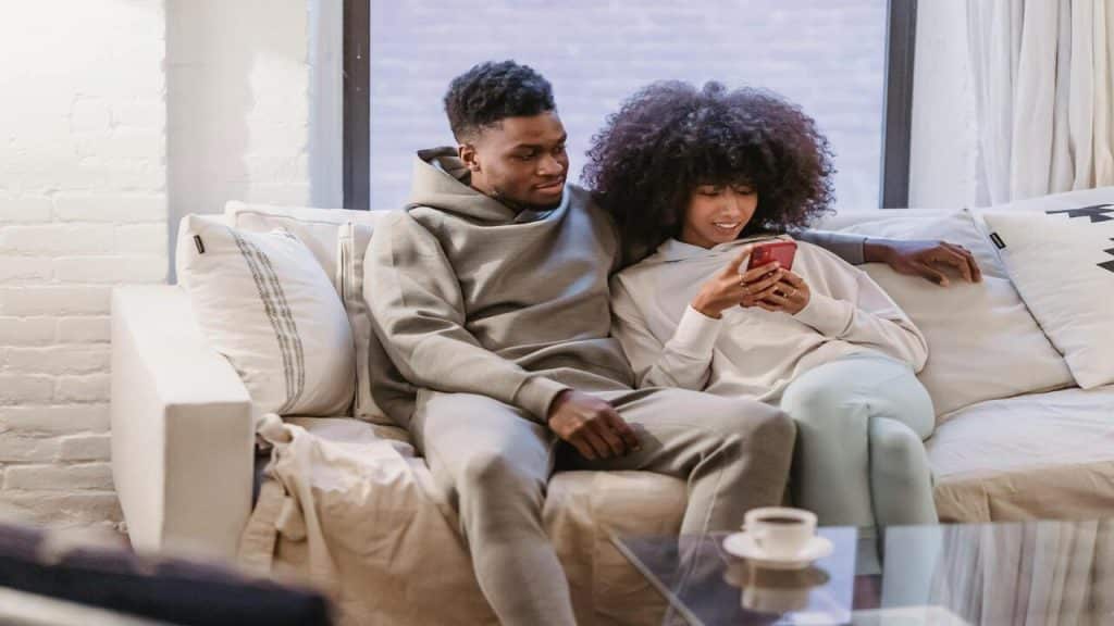 A man watching his wife texting