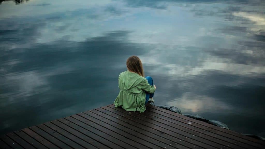 A woman sitting on a dock