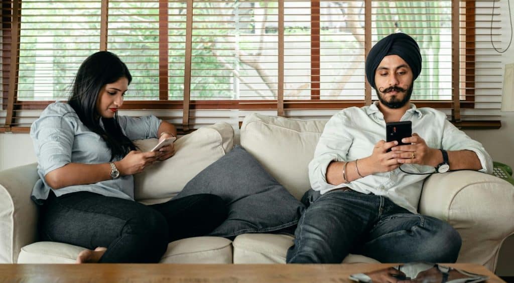 A man and woman using their phone