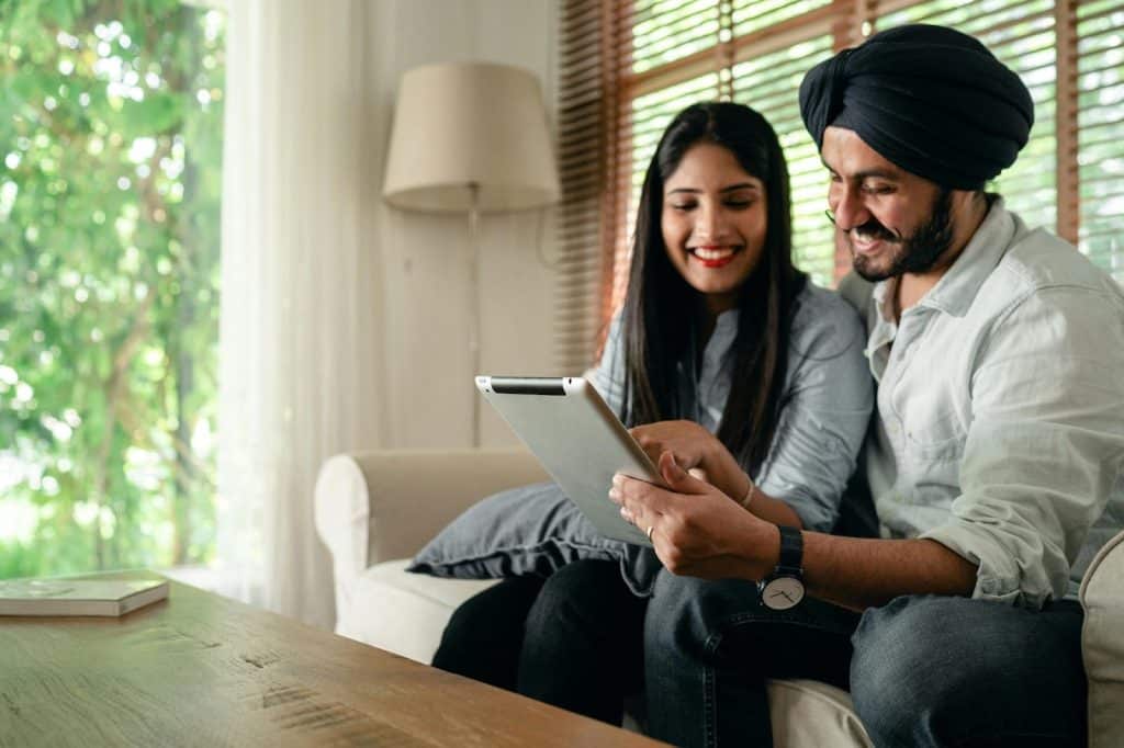 A man and woman checking their social media accounts