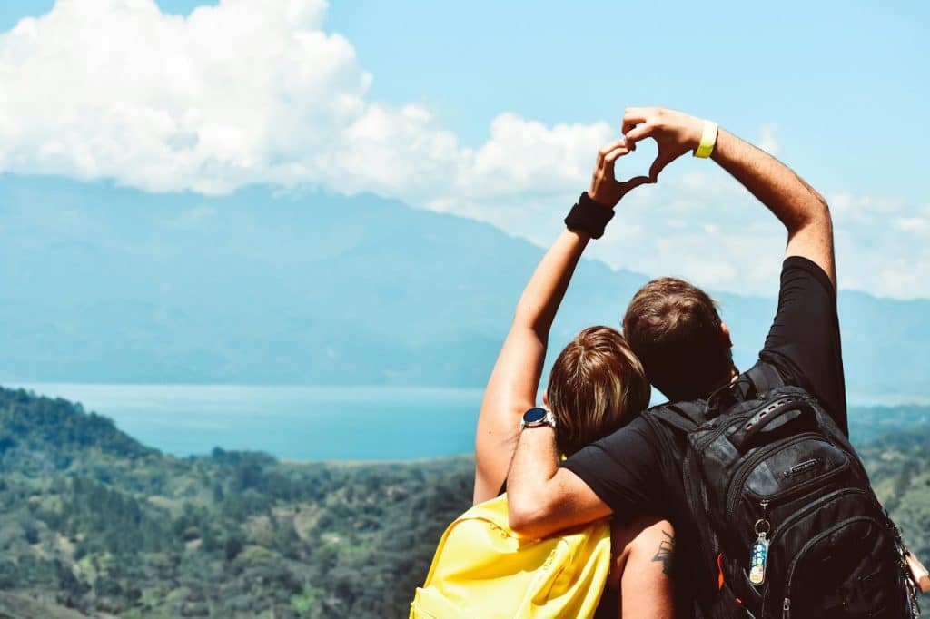 Couple forming a heart on their hands 