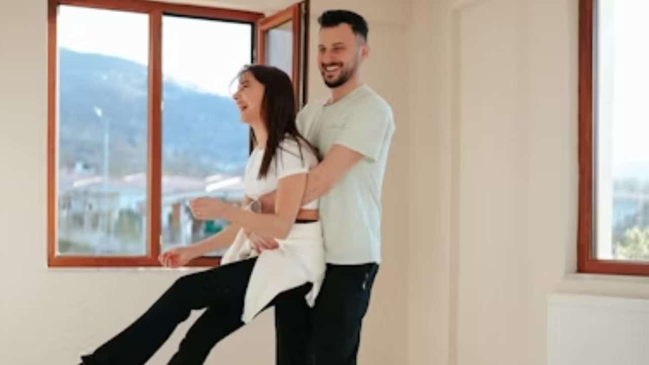 Husband and wife dancing together in their living room.