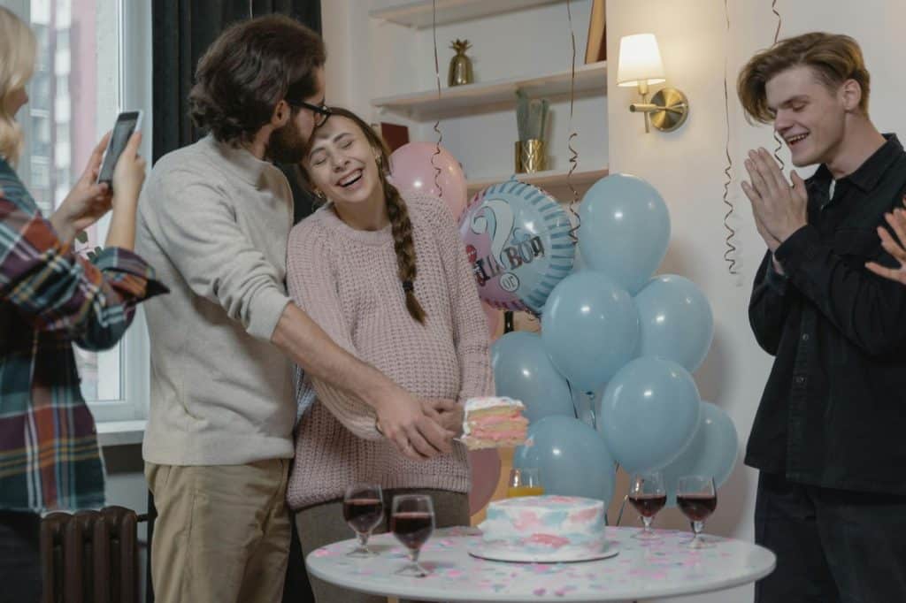 A man and woman having a gender reveal party