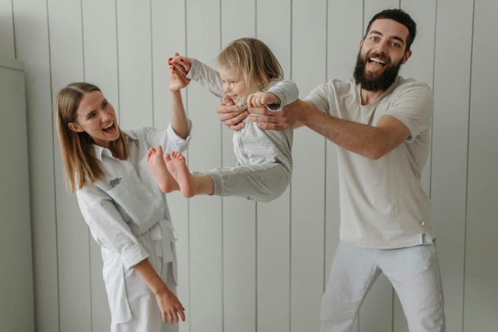 A man and woman playing with their child