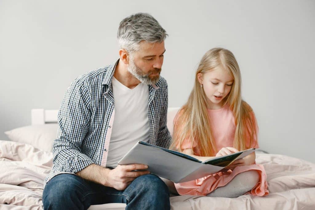 A father reading a book with daughter