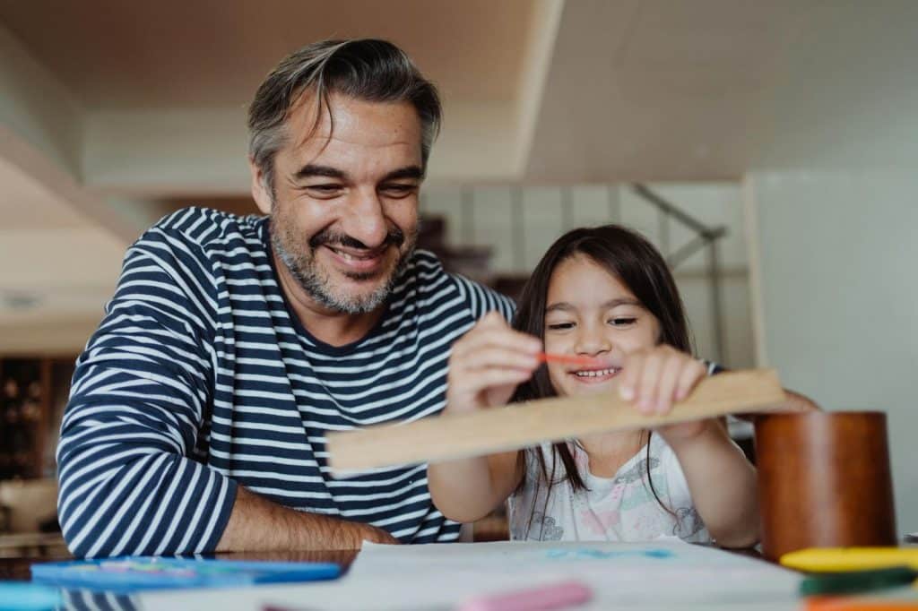 A man guiding his daughter 