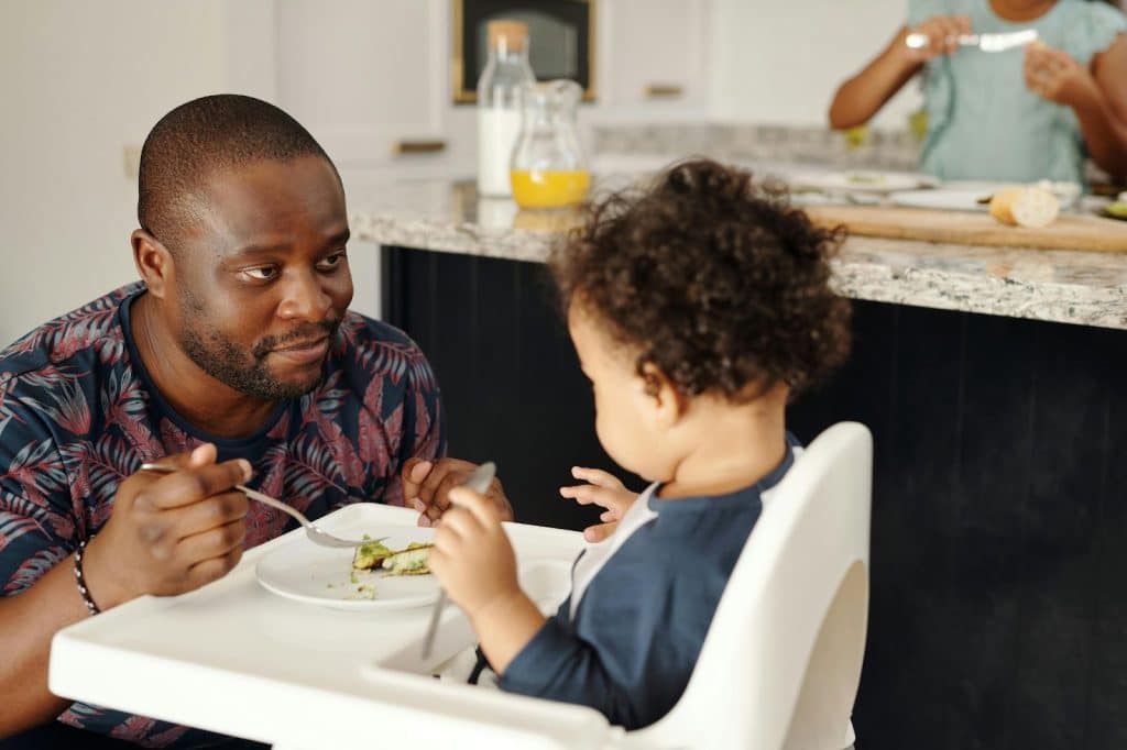 A man feeding a baby