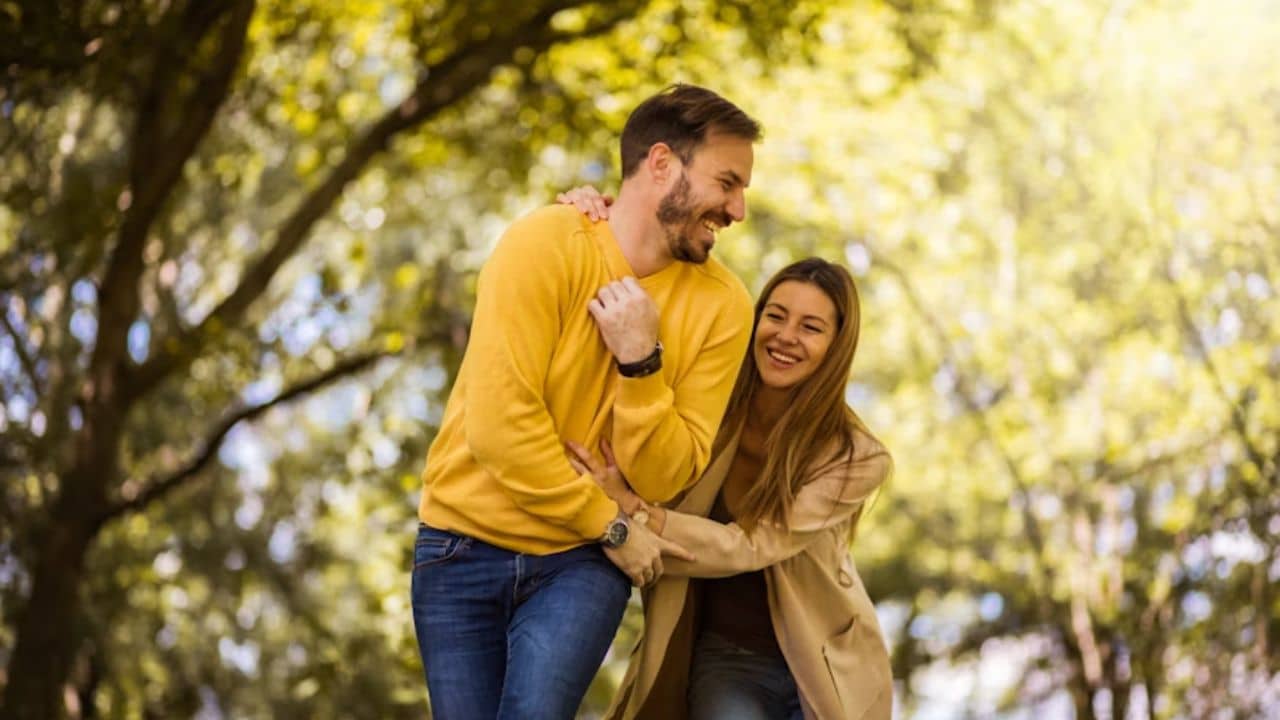 Happy couple walking together outdoors with a sense of balance and connection.