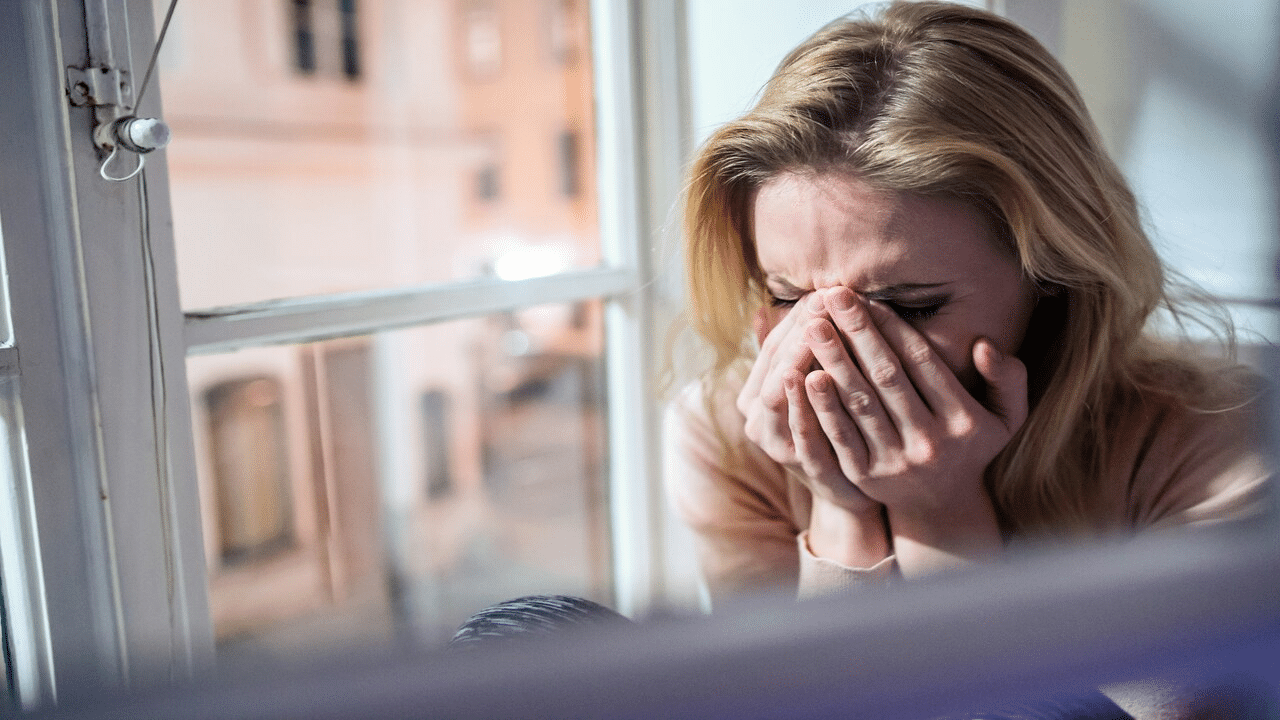 A woman crying at home.