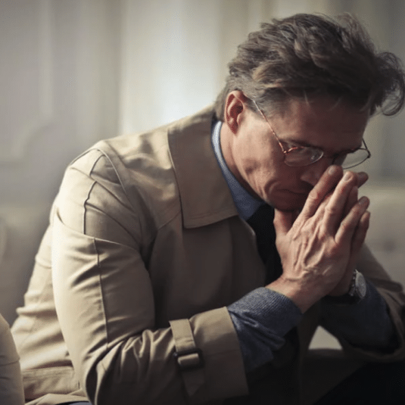 A man looking sad at home.