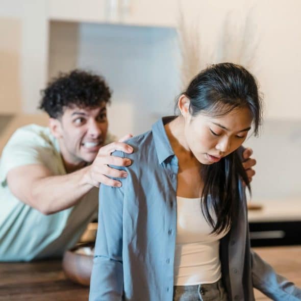 A man holding a shoulder of a woman