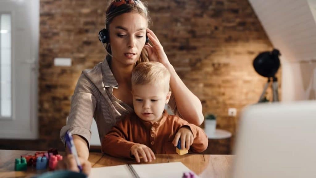 A household imbalance, woman working while taking care of a kid