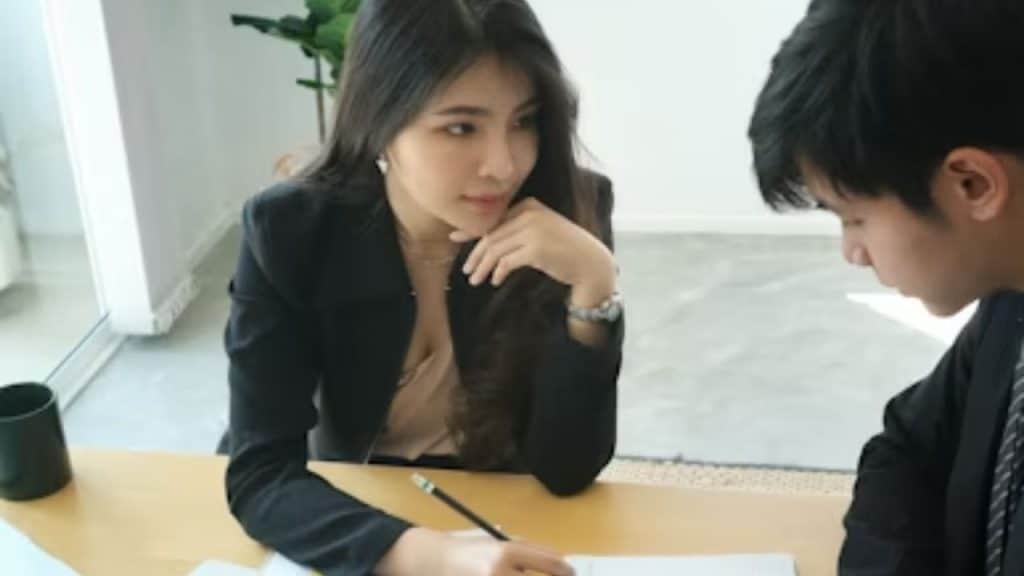 A woman presenting an idea in a bright office while her partner looks dismissive