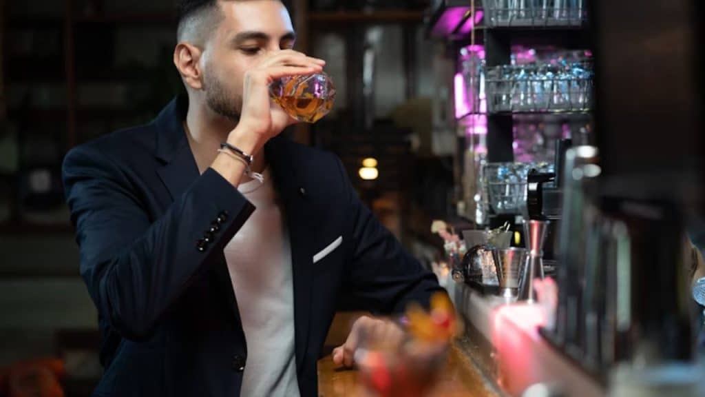 A man drinking alone at night