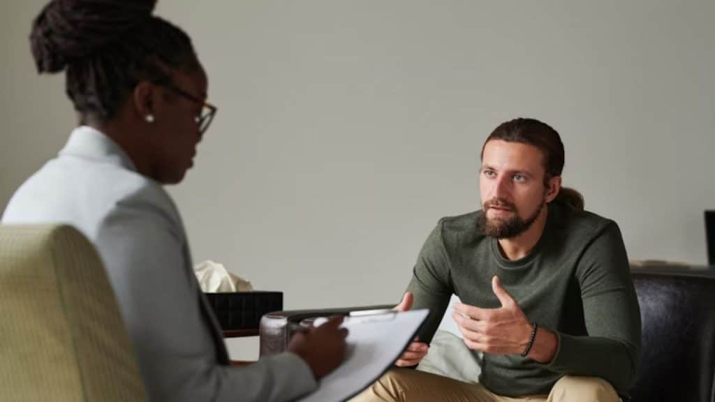 A man in therapy session talking openly to a counselor