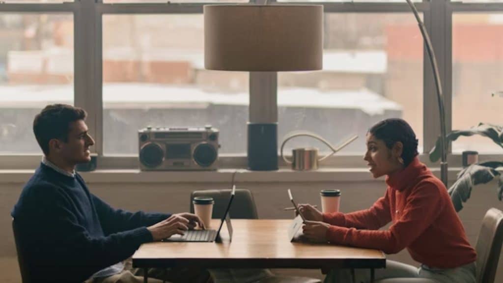 A couple sitting at a café, one partner looking hopeful while the other looks distant
