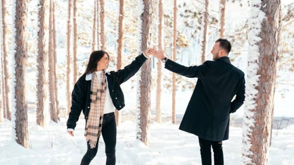 A couple holding hands in a hopeful outdoor setting