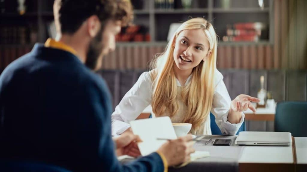 Woman looking thoughtful while on a date with a man who seems distracted