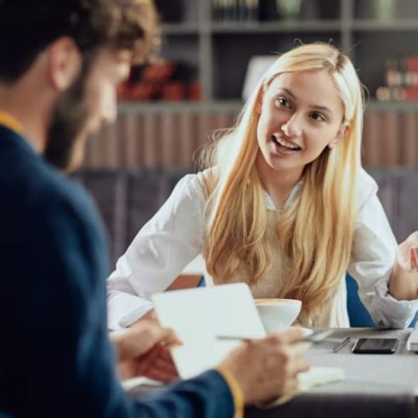 Woman looking thoughtful while on a date with a man who seems distracted