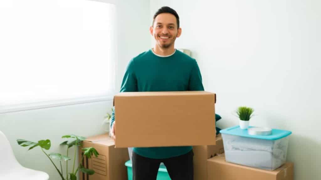 Man packing boxes moving into his own place