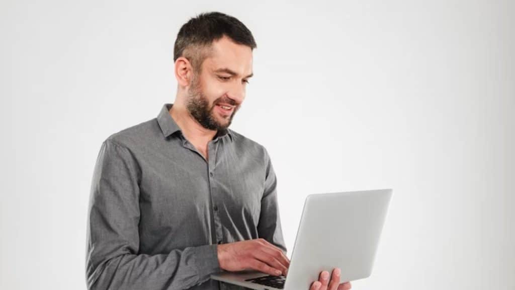 Man confidently closing laptop after work hours