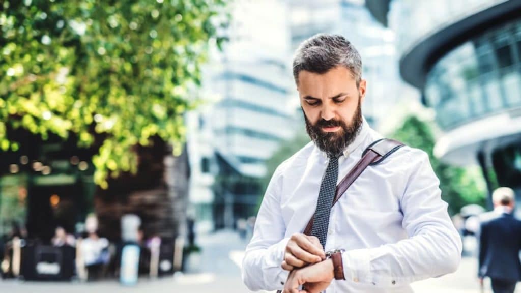 Man checking watch while leaving home