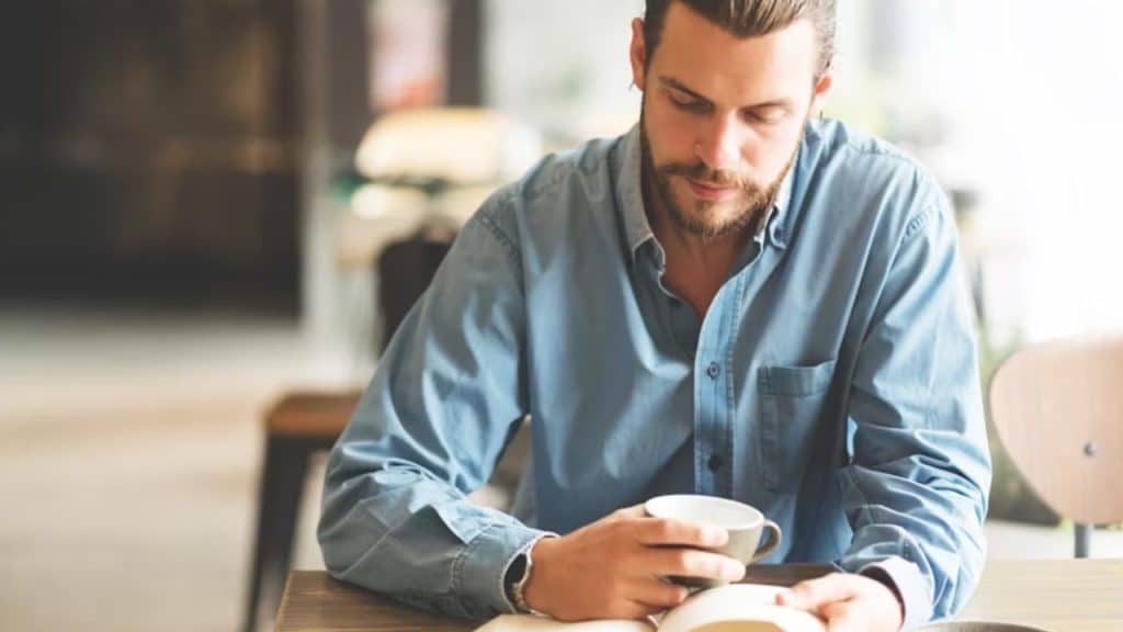 Man reading a book in a cozy room