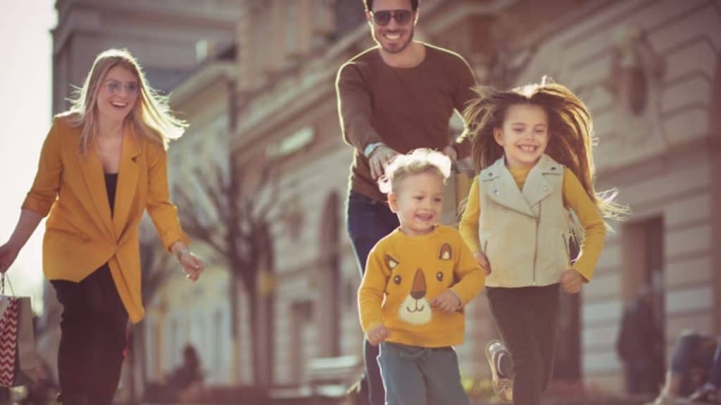 Man walking with family, holding protective stance