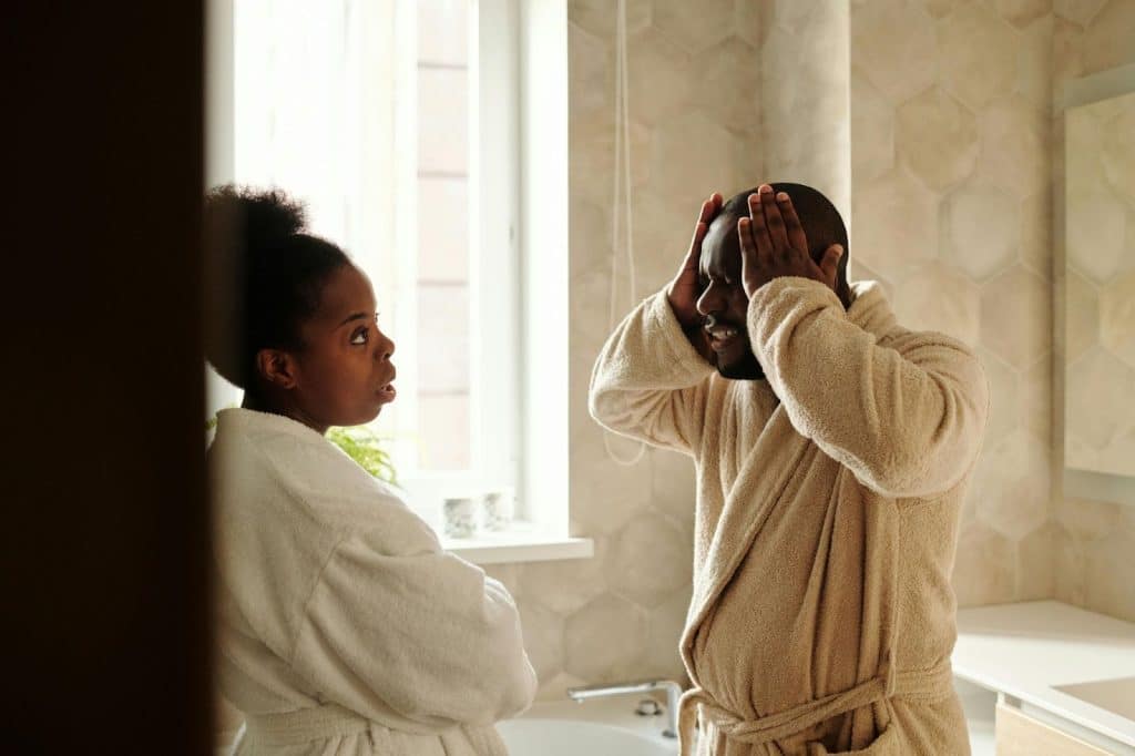 A man looking frustrated talking to his wife