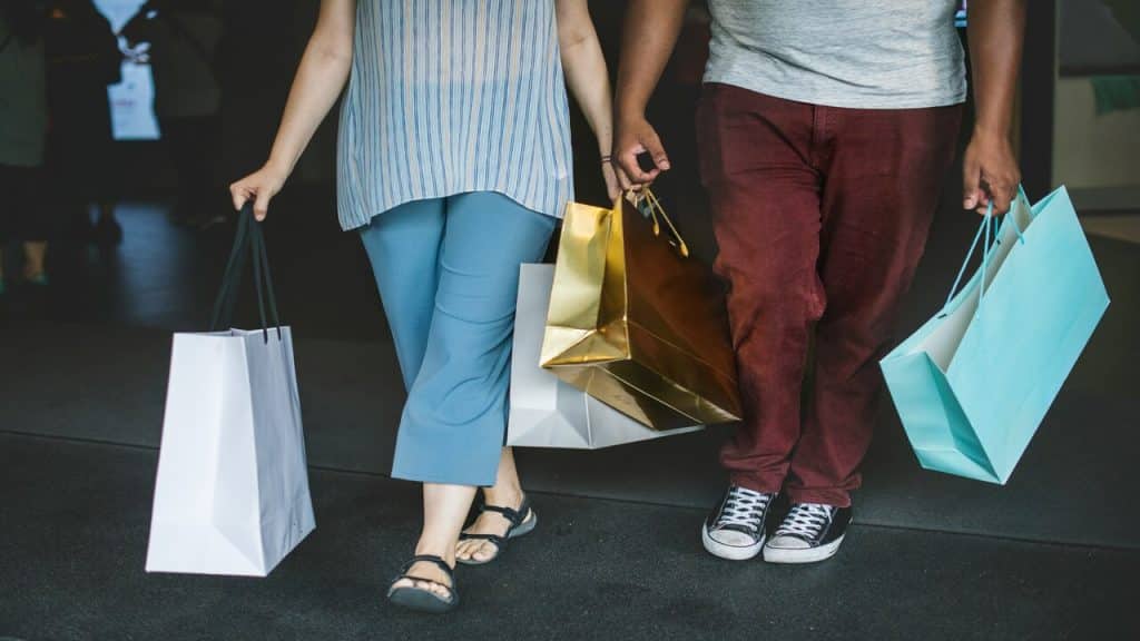 A couple carrying shopping bags
