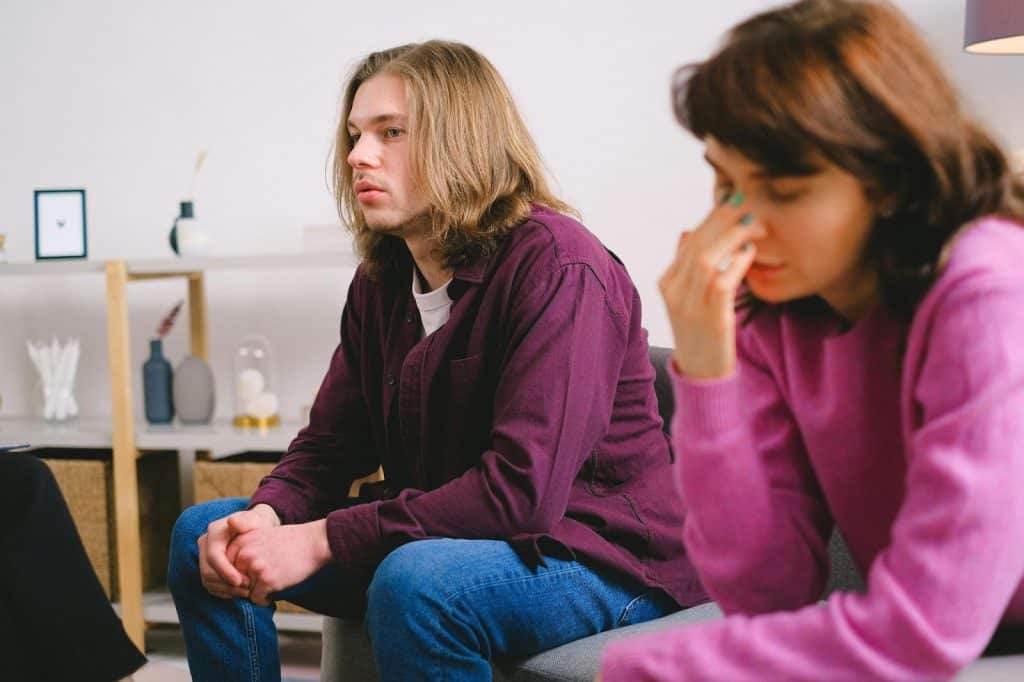 A man and woman just sitting at the couch