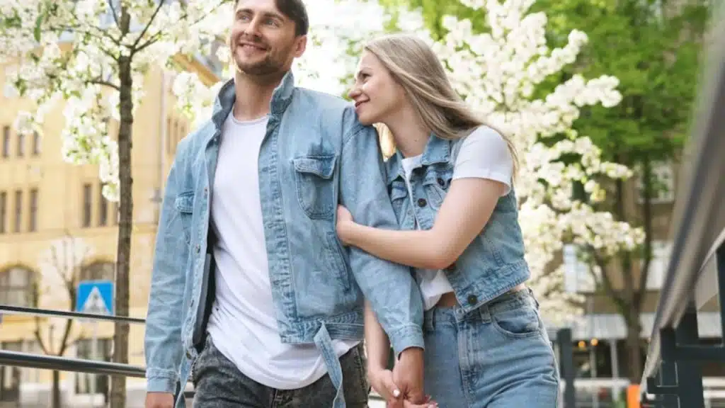 Couple smiling while walking together on a city street