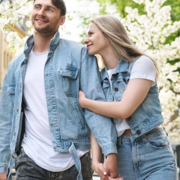 Couple smiling while walking together on a city street
