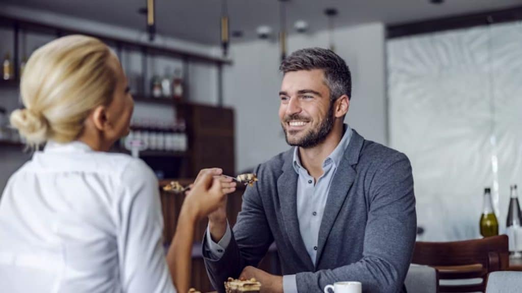 Woman talking as man listens attentively over dinner