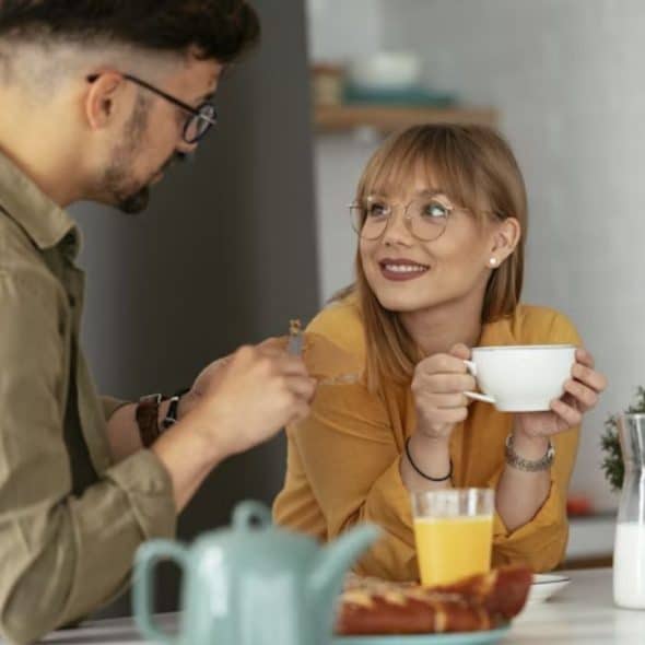 Woman smiling while holding eye contact with a man