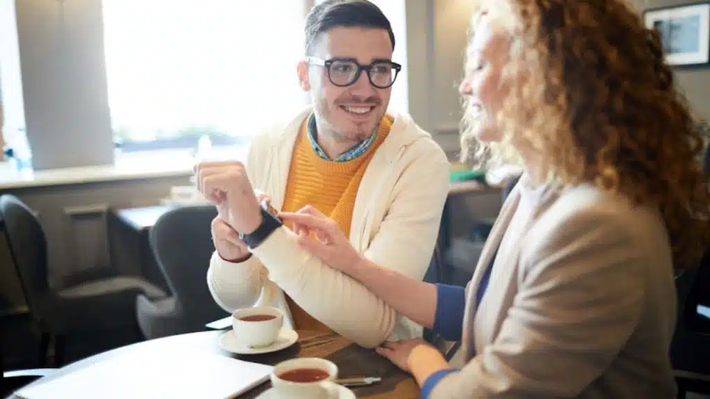 Woman casually touching a man’s arm while laughing