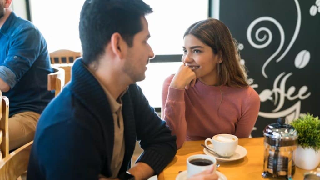 Woman leaning in close to a man during a conversation