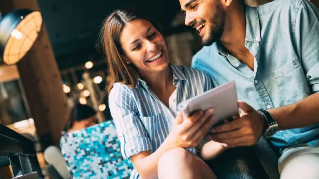 Woman laughing brightly in response to a man’s joke