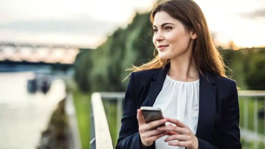 Woman smiling at her phone while texting
