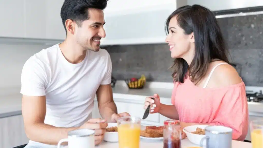 Woman blushing slightly while smiling at a man