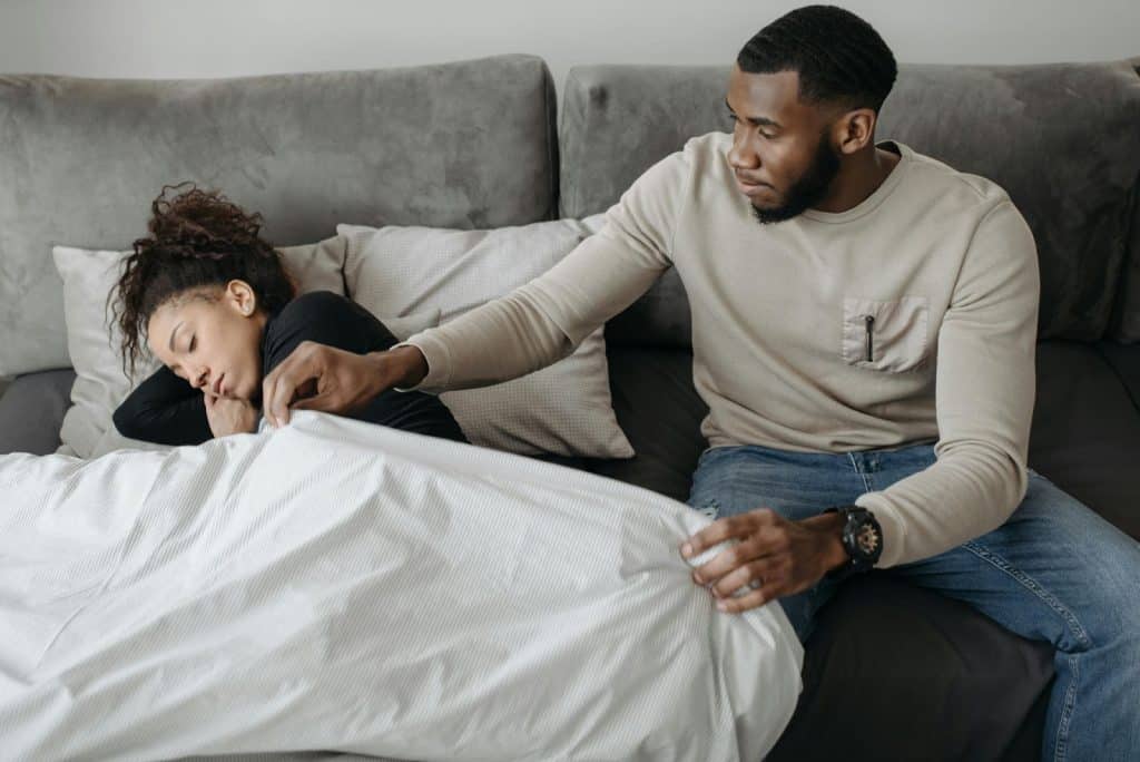 A man taking care of a woman