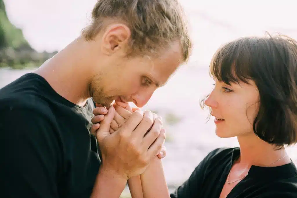 A man kissing a woman’s hand