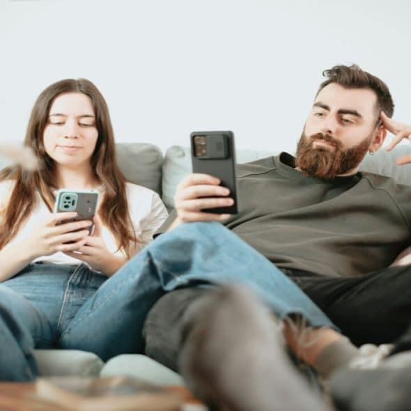 A couple looking bored at home.