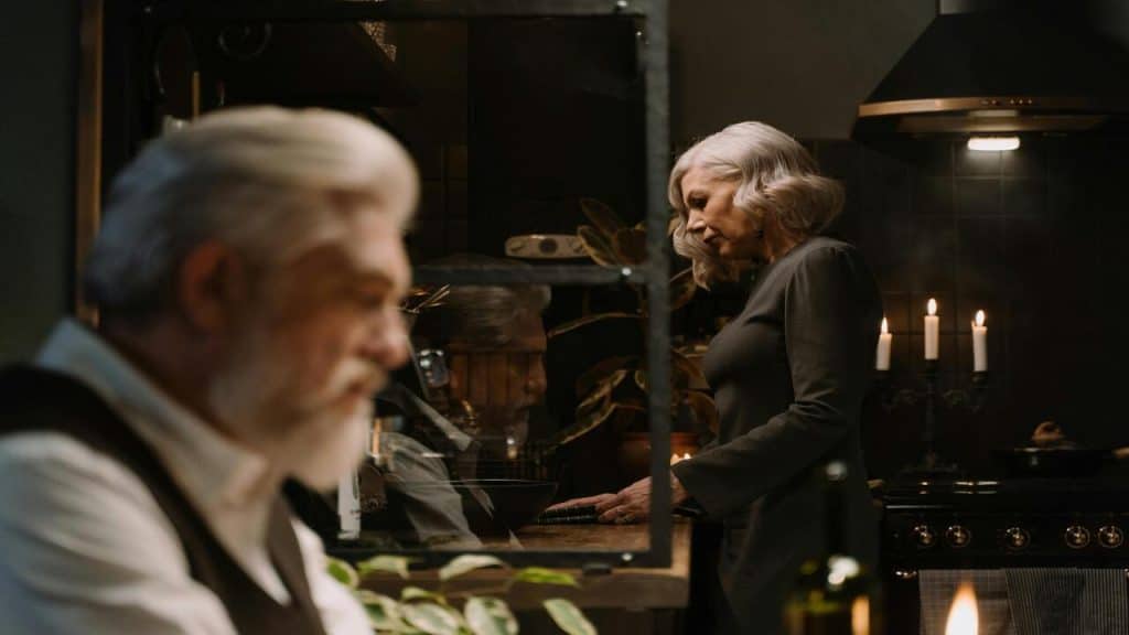 An older couple looking sad in the kitchen