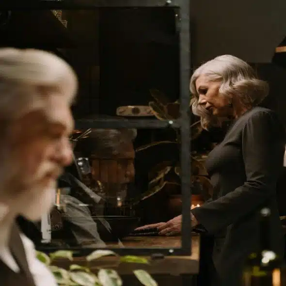 An older couple looking sad in the kitchen