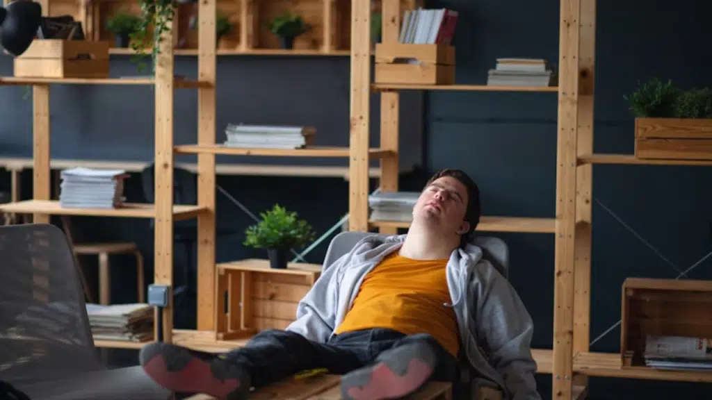 Man in casual clothes slouched on a couch